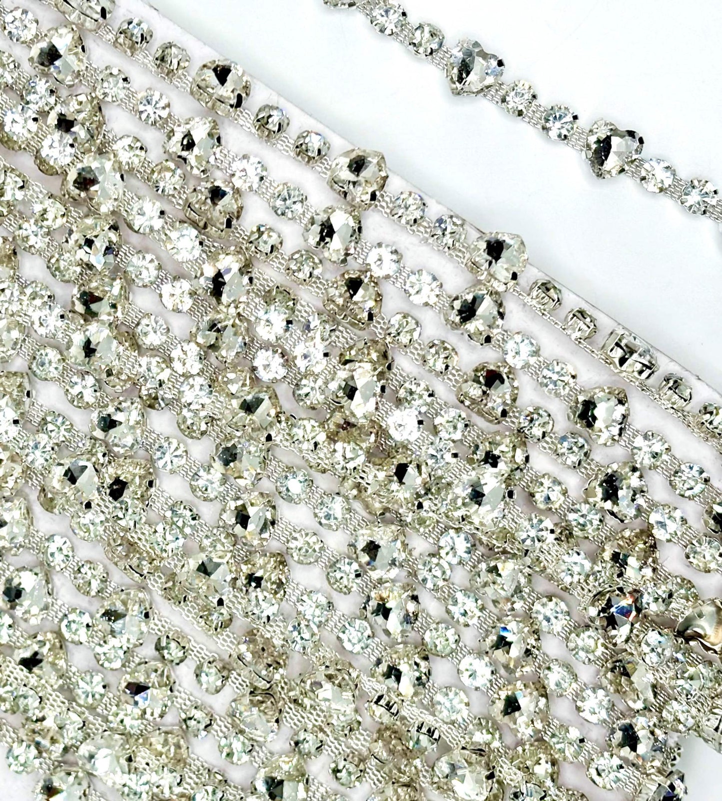 Clear round and heart rhinestone yardage on silver chain back.