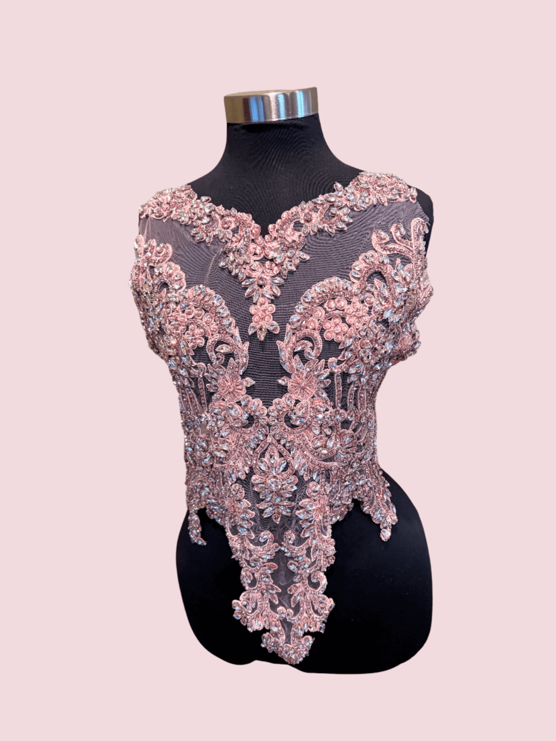 Pink Handmade rhinestone bodice applique with intricate beadwork on mannequin.