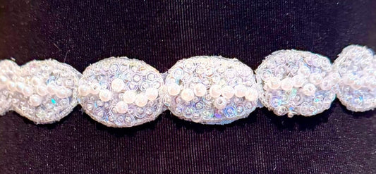 Pearl and iridescent sequin beaded oval yardage embellishment on fabric.