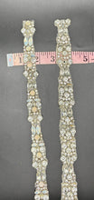Madison's Yardage clear rhinestones yardage with opals on black background.
