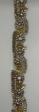 "Genesis" Rhinestone Yardage in clear and gold, approximately 1 3/4" wide.