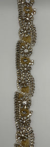 "Genesis" Rhinestone Yardage in clear and gold, approximately 1 3/4" wide.