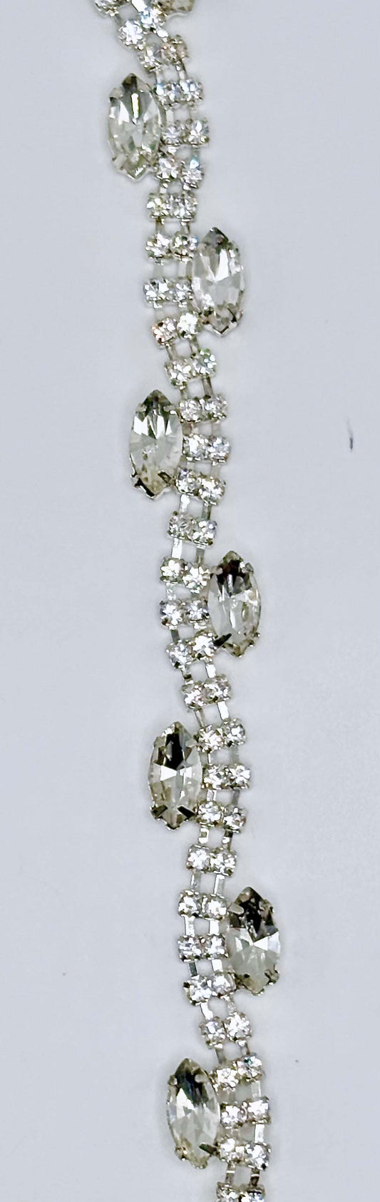 "Allison" Rhinestone Yardage with clear rhinestones on silver trim, approximately 3/8" wide.