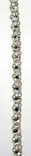 "Annah" Rhinestone Yardage with clear rhinestones on silver trim, approximately 1/2 inch wide.