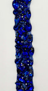 Handmade multi-stone yardage with vibrant blue rhinestones on a 1-inch wide trim.
