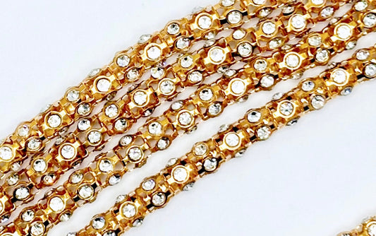 Metal rhinestone rope with clear rhinestones on gold metal backing, 6mm width.