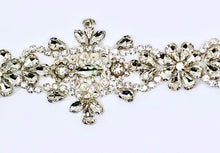 Handmade clear rhinestone bridal belt on silver background.
