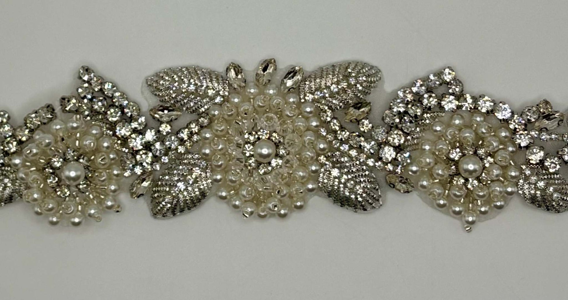 Handmade bridal belt with rhinestone and pearl appliqué.