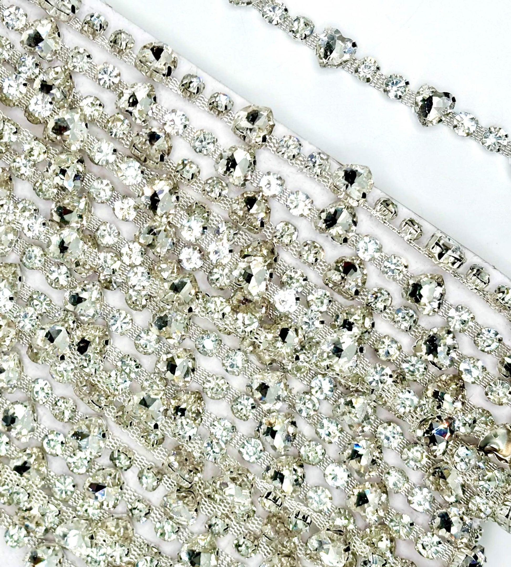 Clear round and heart rhinestone yardage on silver chain back.