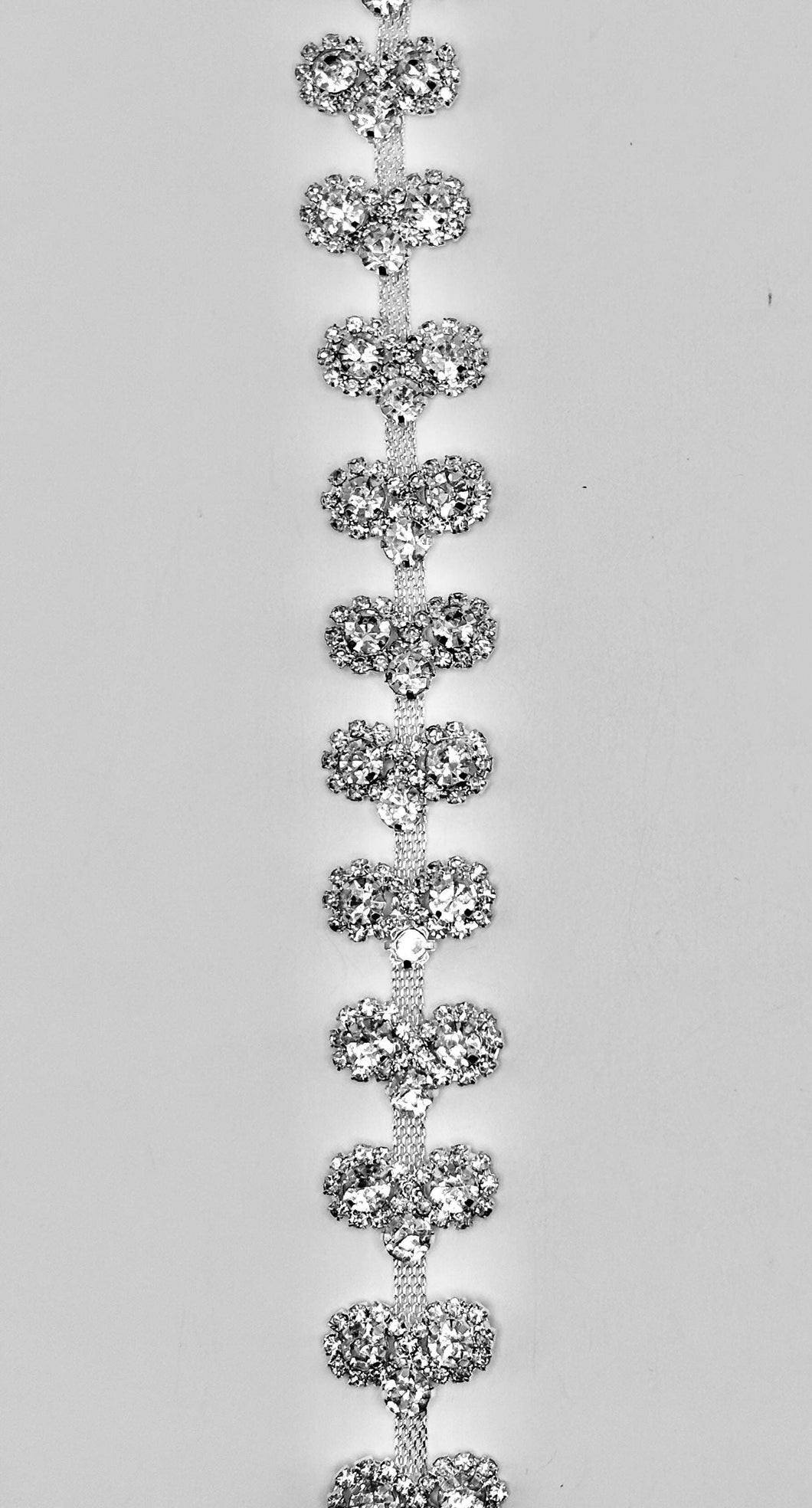 Clear rhinestones on silver chain back setting, approximately 3/4