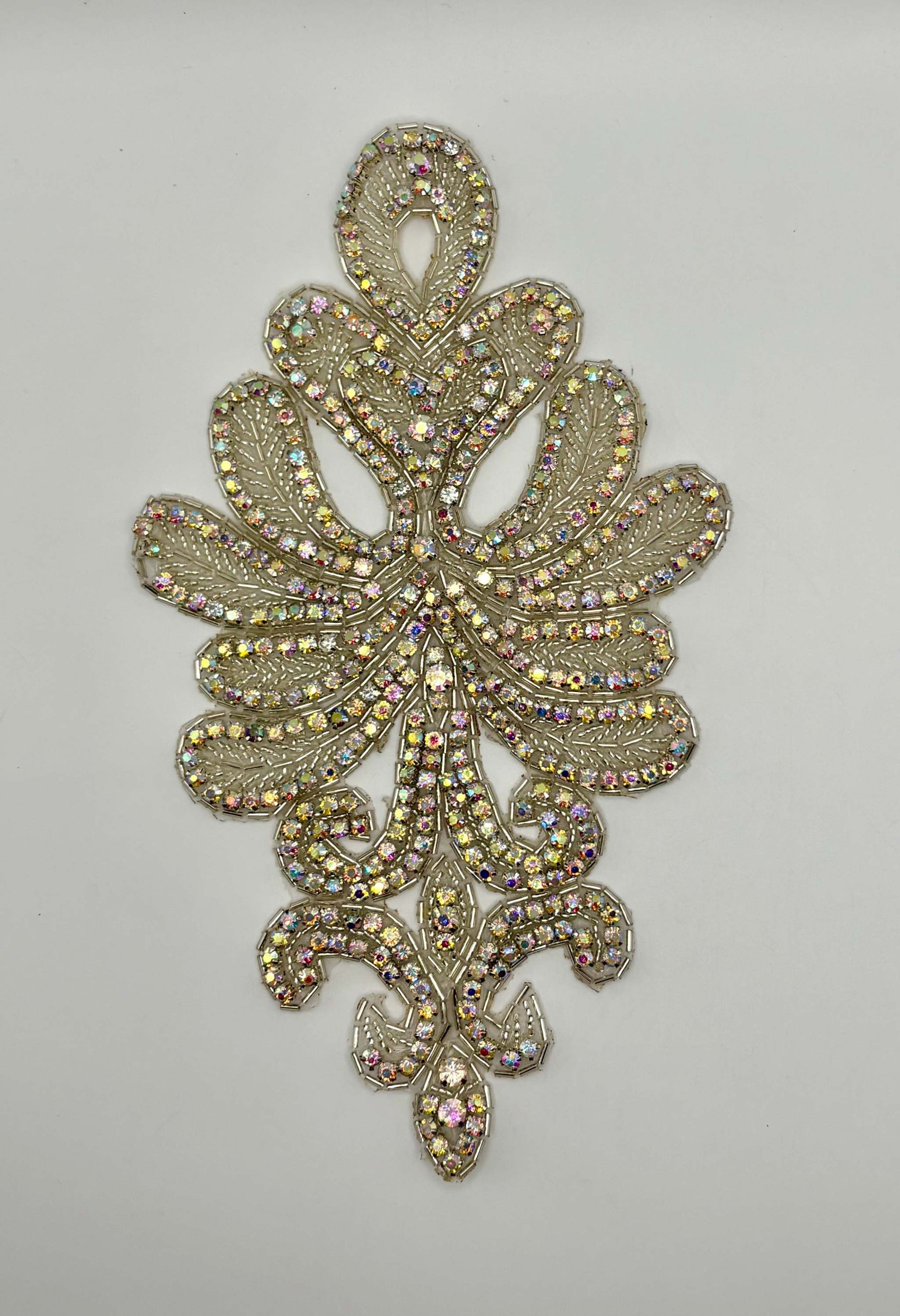 Handmade beaded accent with rhinestones in decorative pattern.