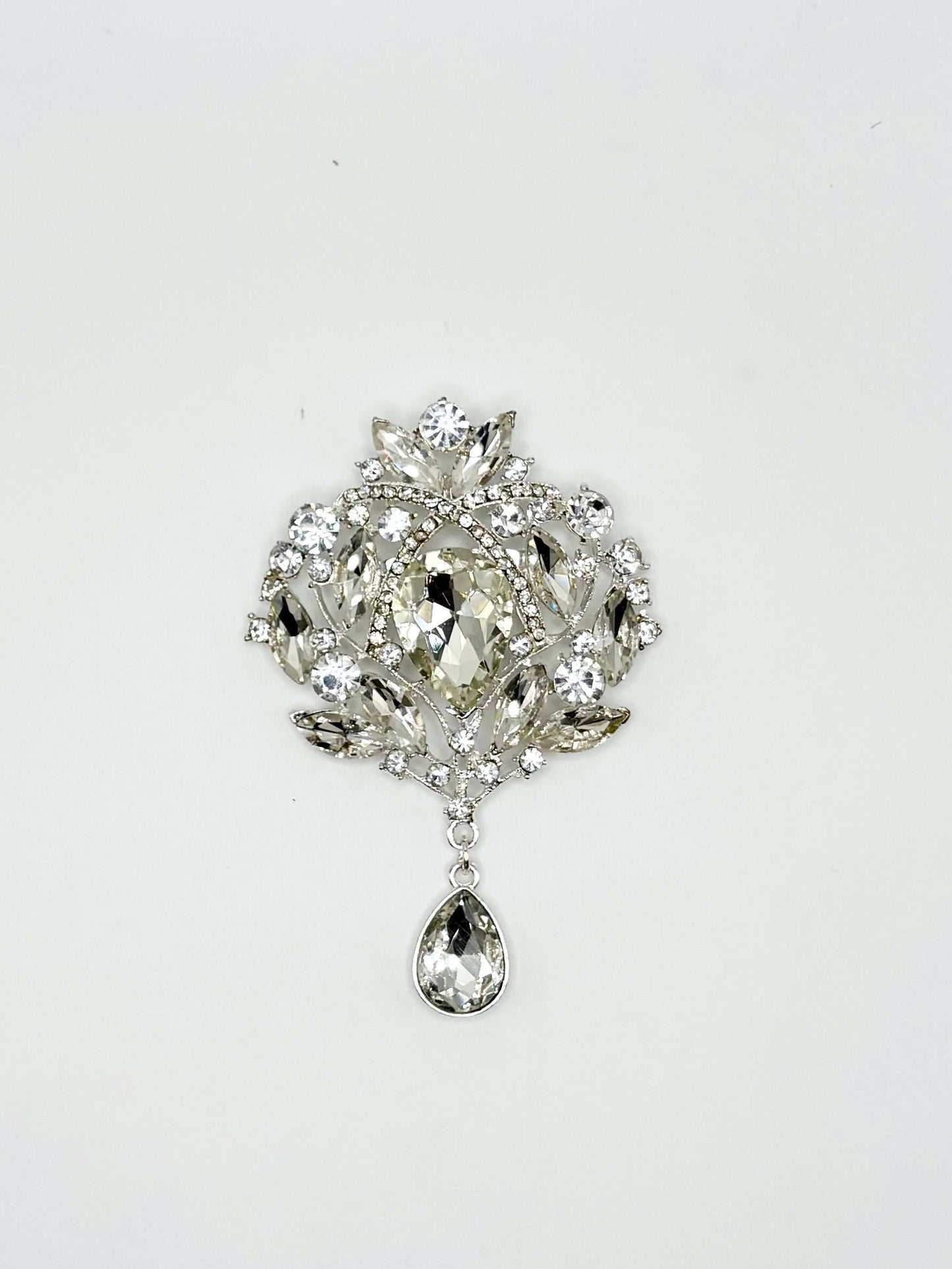 "Misti Thomas" rhinestone broach with clear stones in silver setting.