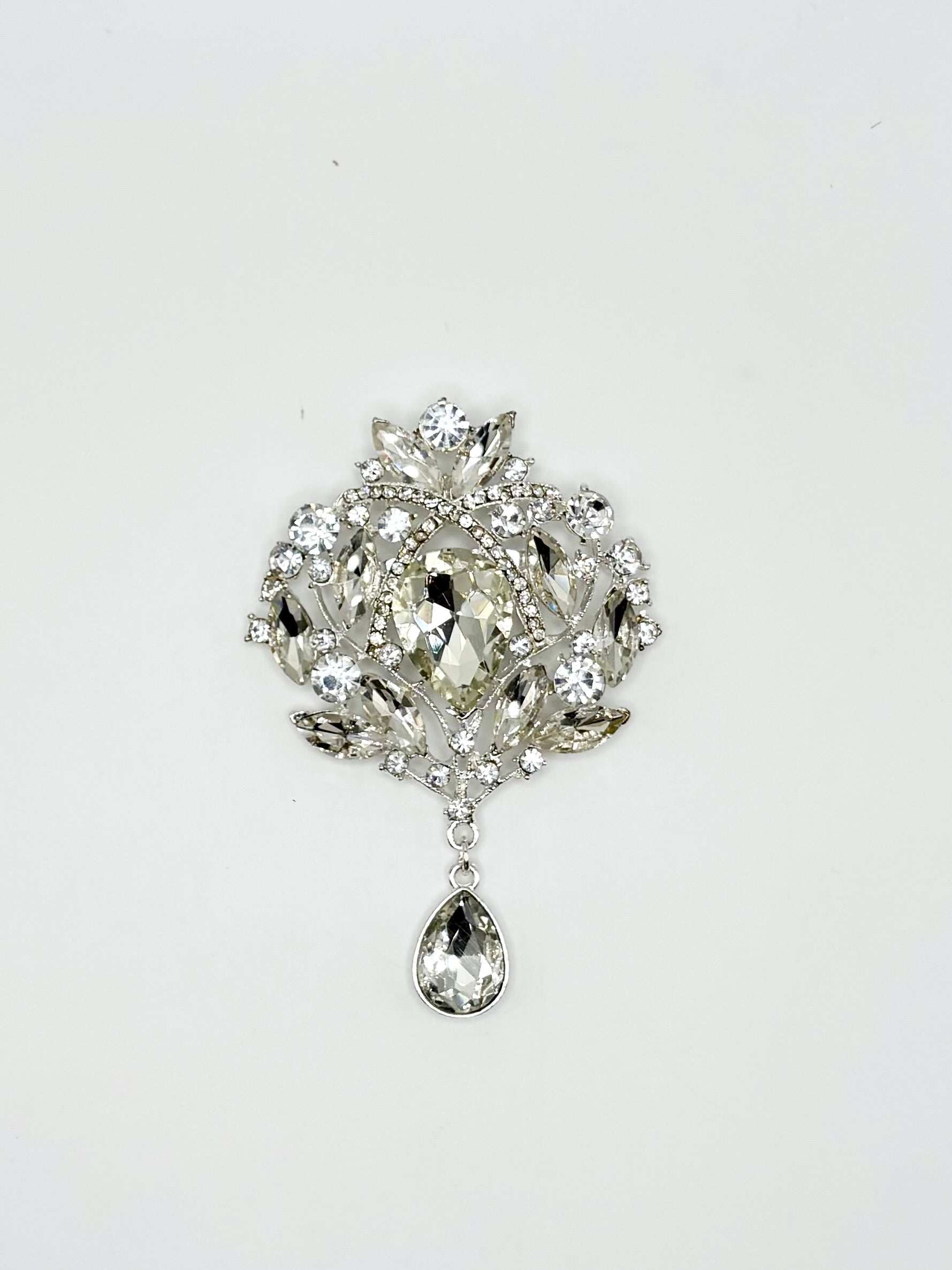 "Misti Thomas" rhinestone broach with clear stones in silver setting.