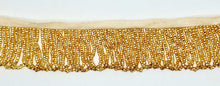 Handmade gold beaded looped fringe trim with glass beads, 1.5 inches wide, ideal for bridal wear and couture designs.