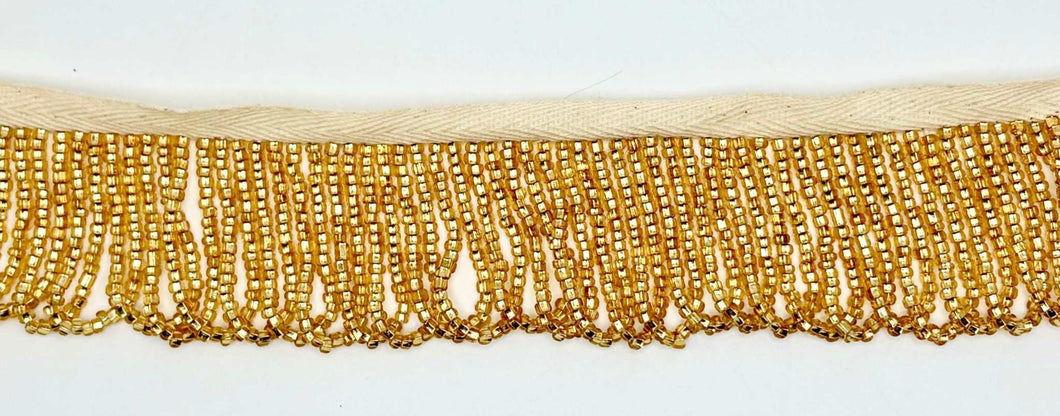 Handmade gold beaded looped fringe trim with glass beads, 1.5 inches wide, ideal for bridal wear and couture designs.
