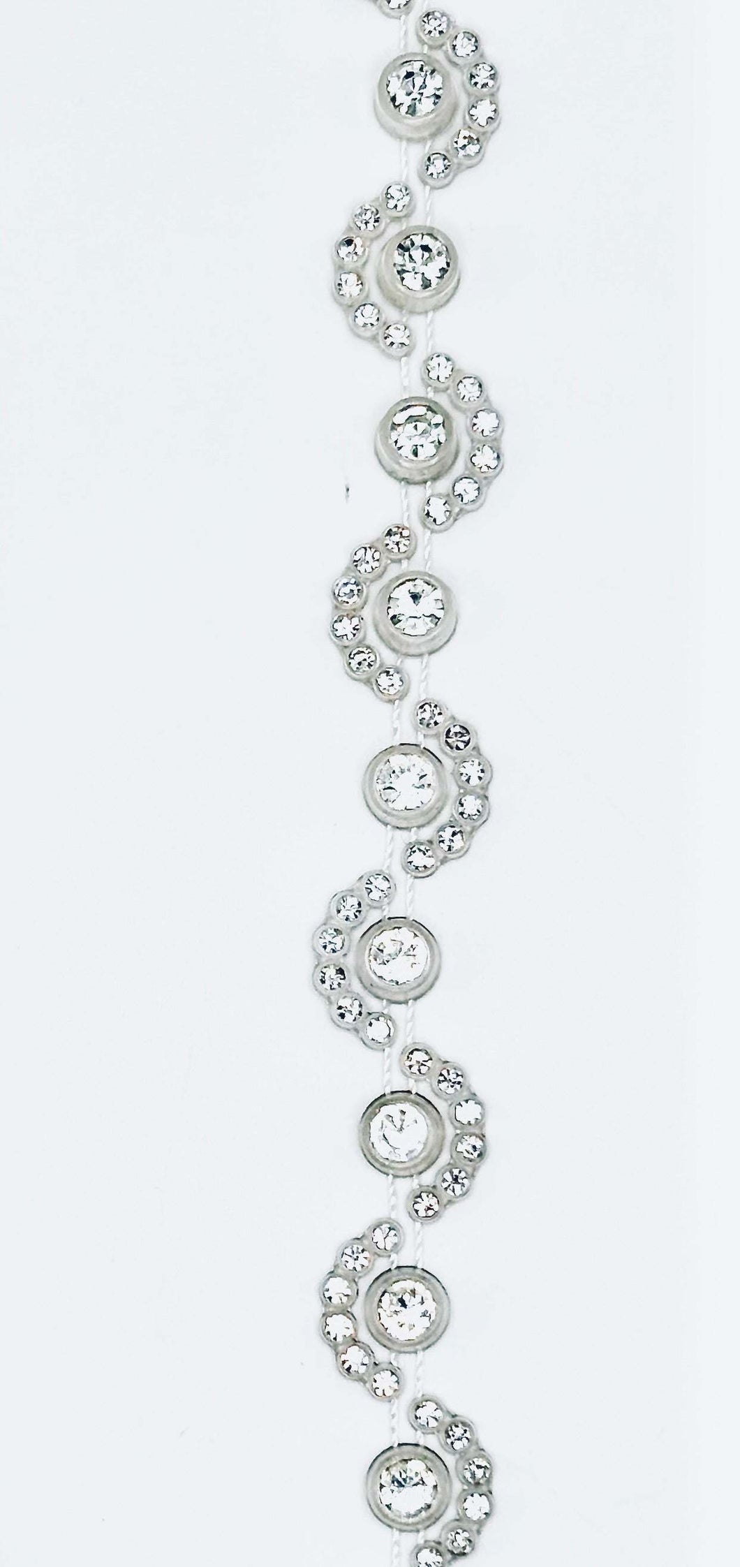 Rhinestone silicone mesh trim in wave pattern with clear crystal rhinestones on flexible mesh.